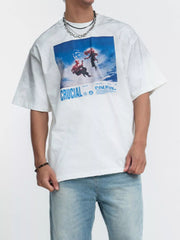 Model wearing white graphic T-shirt with blue print