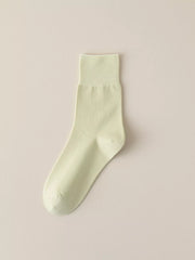 Pale green solid-color crew sock displayed flat