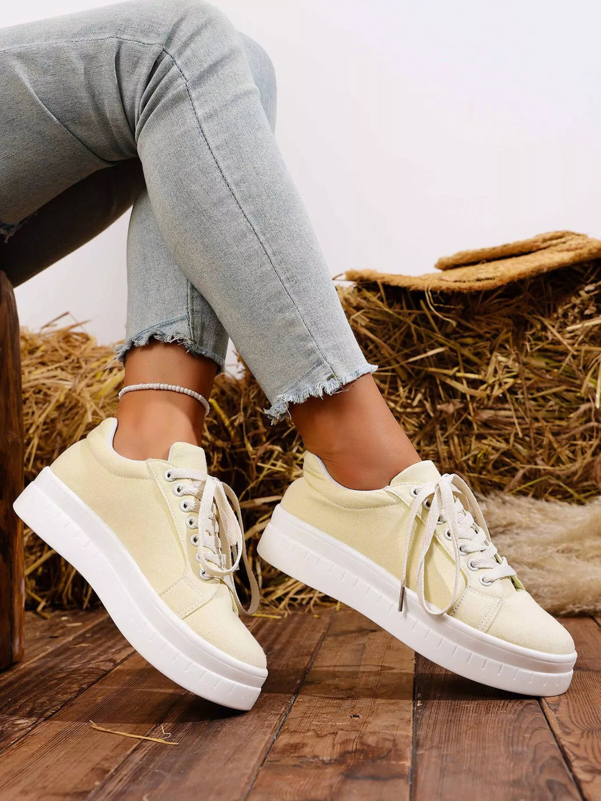 Pair of white platform sneakers, side view
