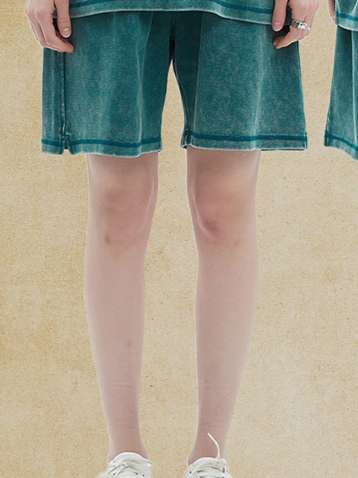 Model wearing deep teal elastic-waist shorts