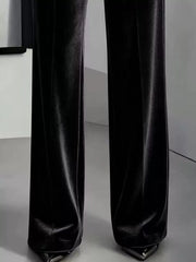 Close view of black velvet wide trouser legs and hems