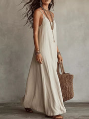 Side view of beige sleeveless maxi dress with flowing skirt