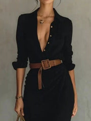 Close view of the black shirt dress's collar, buttons and brown belt.