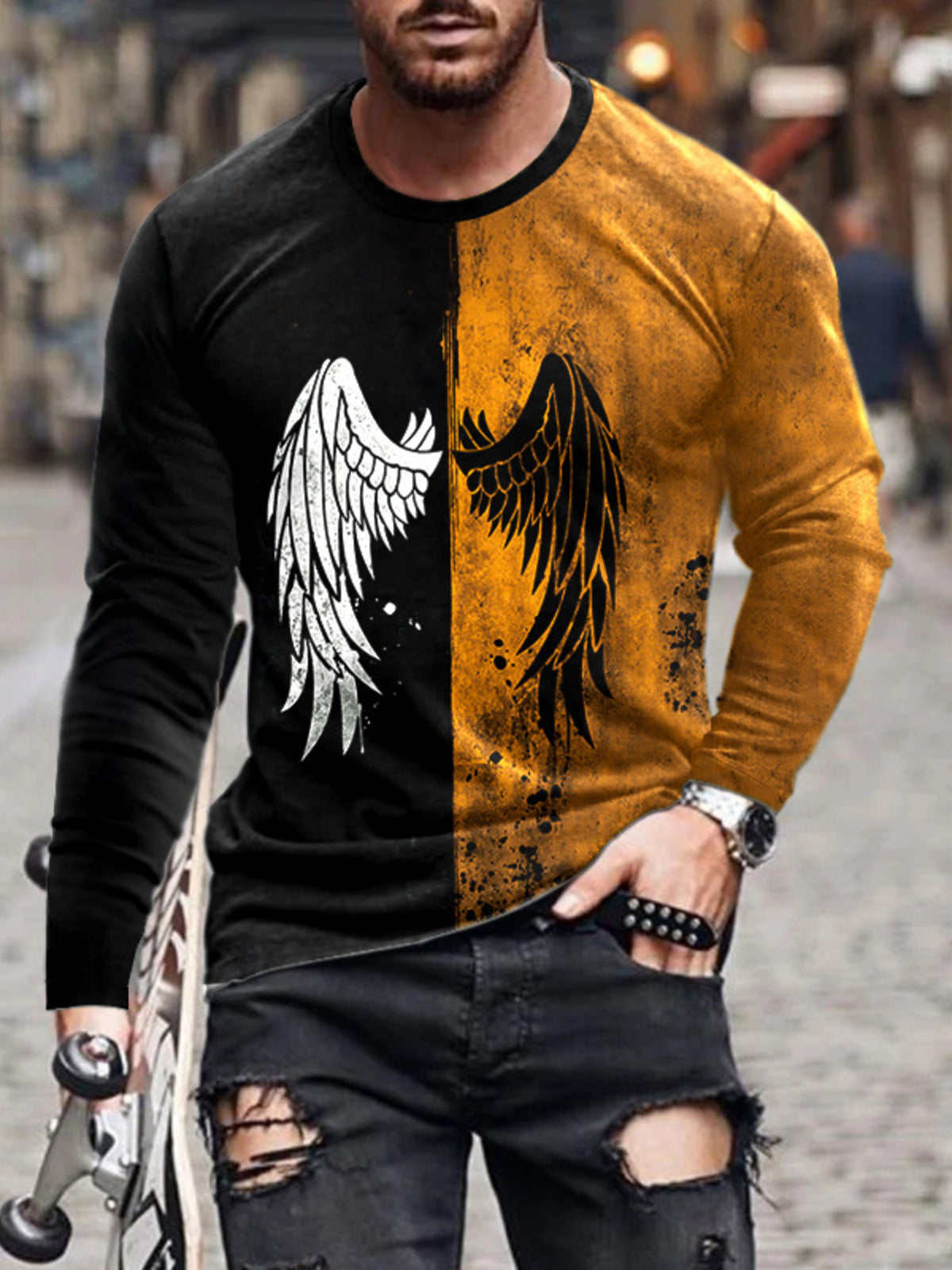 Model wearing split black and mustard long-sleeve shirt with wing graphic
