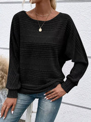 Women’s ribbed round-neck long-sleeve top in black front view with hand at hip