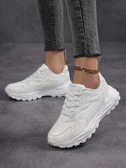 Pair of white platform sneakers on feet