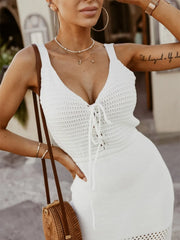 Front view of white sleeveless sweater dress with lace-up neckline and side slit