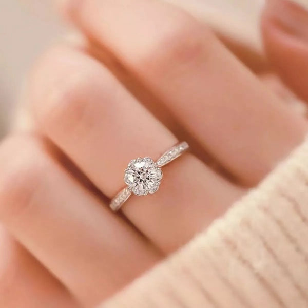 1 carat round moissanite ring worn on a hand