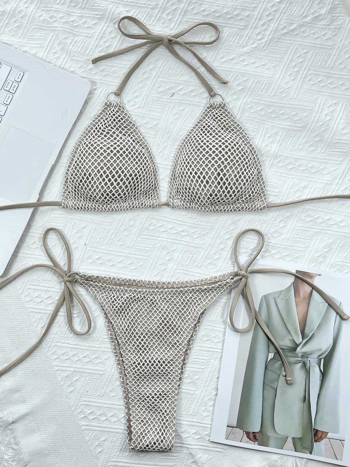 Cream mesh triangle bikini top and tie-side bottoms laid flat on white fabric