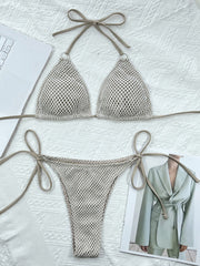 Cream mesh triangle bikini top and tie-side bottoms laid flat on white fabric