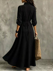 Back view of black maxi dress showing waist tie and flowing skirt