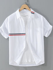 White short-sleeve button-front shirt with red and navy contrast stripes, shown on a hanger