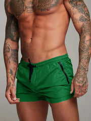 Model wearing green drawstring active shorts