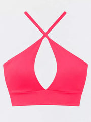 Back view of bright pink halter crop cami with crossed straps
