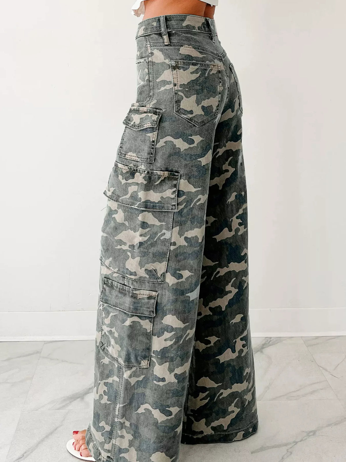 Side view of gray camo wide-leg jeans with cargo pocket