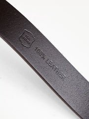 Embossed 100% LEATHER marking on the underside of a black belt