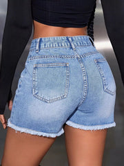 Back view of light-wash denim shorts with two pockets and frayed hems