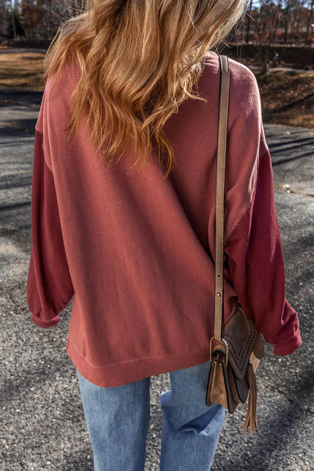 Back view of mauve sweatshirt on model