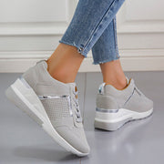Gray wedge sneakers viewed from behind