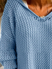 Close-up of the V-neck and open stitch texture on a blue knit cover-up.