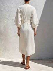 Back view of white midi dress showing gathered tie waist