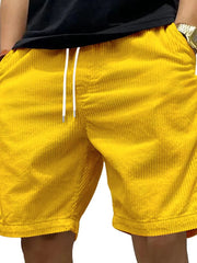 Model wearing yellow drawstring shorts, back view