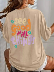 Back of a khaki oversized tee with a multicolor See Good in All Things graphic