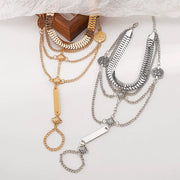 Several layered hand chain bracelets in gold and silver tones