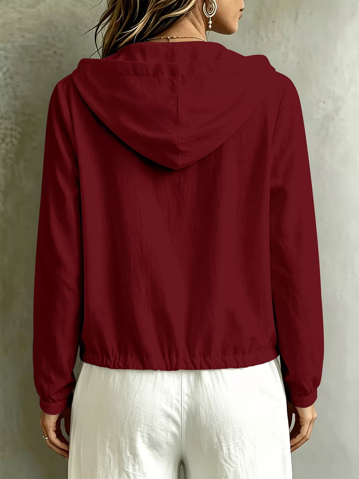 Back view of the burgundy blouse with hood and drawstring hem.