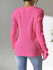 Back view of the pink sweater with plain knit body and diamond-pattern sleeves.