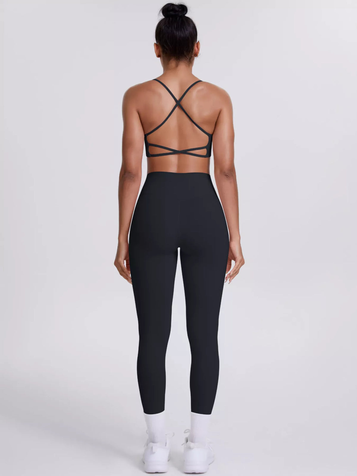 Garment detail view of criss-cross back cami and leggings active set