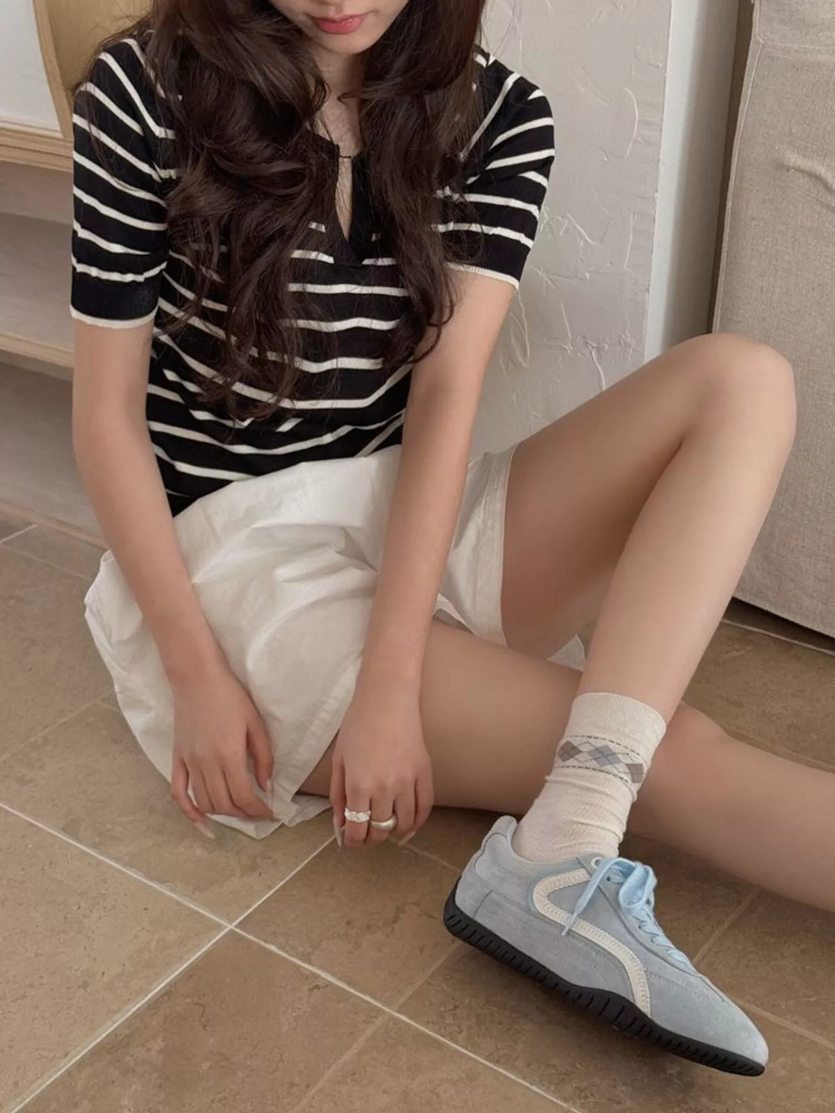 Cream argyle mid-calf socks styled with casual outfit and sneakers