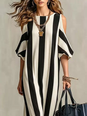 Front view of black and white striped maxi dress with shoulder cutouts