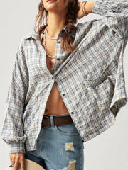 Blue and cream plaid button-up shirt worn open, showing the front and cuffs