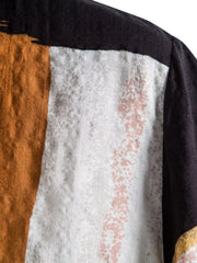 Close-up of white, ochre and black color-block fabric at the shoulder