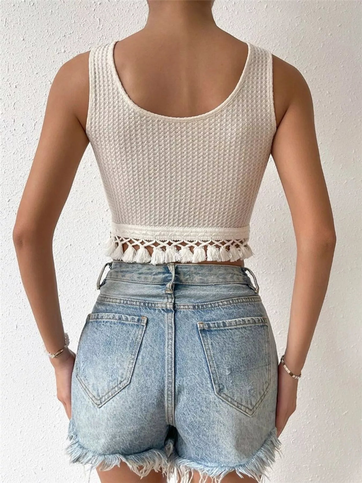Back view showing the textured tank and tassel fringe hem