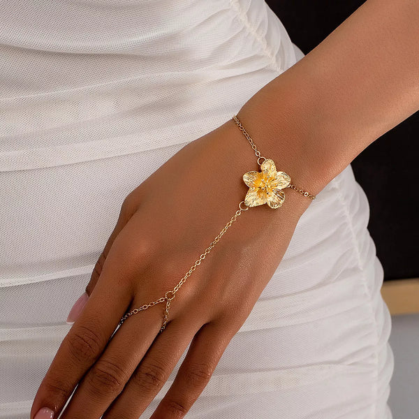Gold-tone floral bracelet with long hand chain and round finger loop