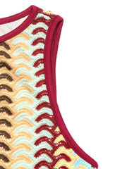 Detail of sleeveless armhole and contrasting trim on chevron knit dress