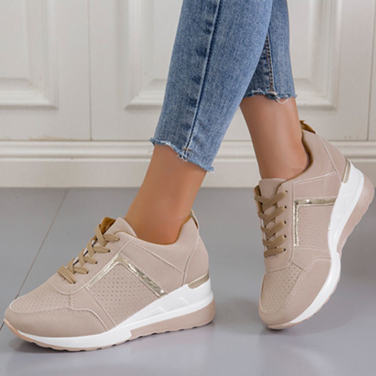 Beige lace-up wedge sneakers worn with jeans