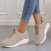 Beige lace-up wedge sneakers worn with jeans