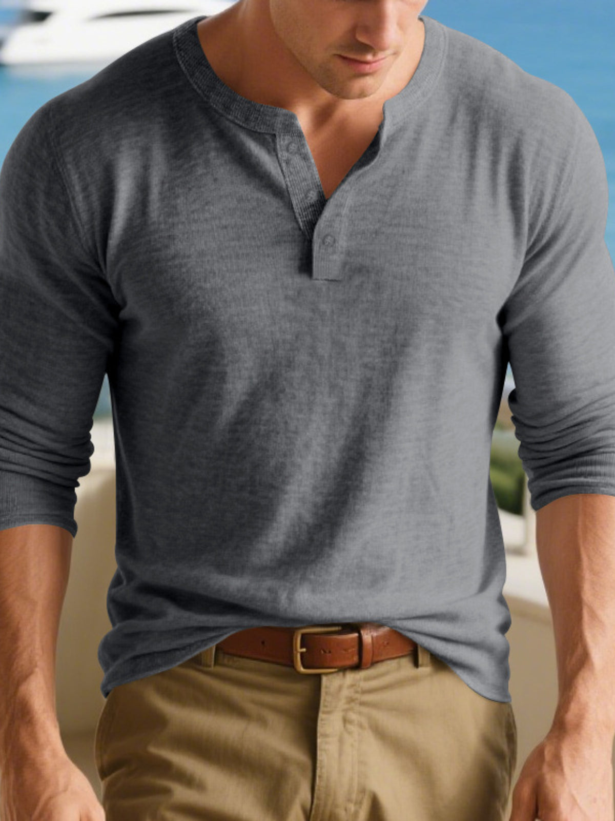 Model wearing a gray long-sleeve Henley shirt with a short button placket.