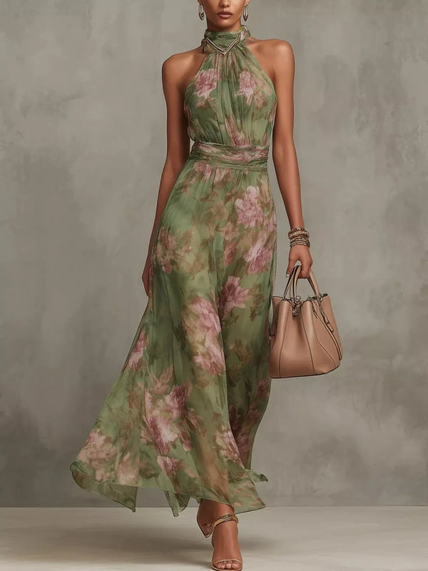 Full-length view of a sleeveless green floral-print maxi dress with a halter neckline.