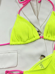 Close-up of neon yellow ribbed triangle cups with pink straps and a small centre ring
