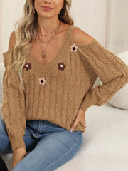 Tan floral-appliqué sweater shown in a seated pose