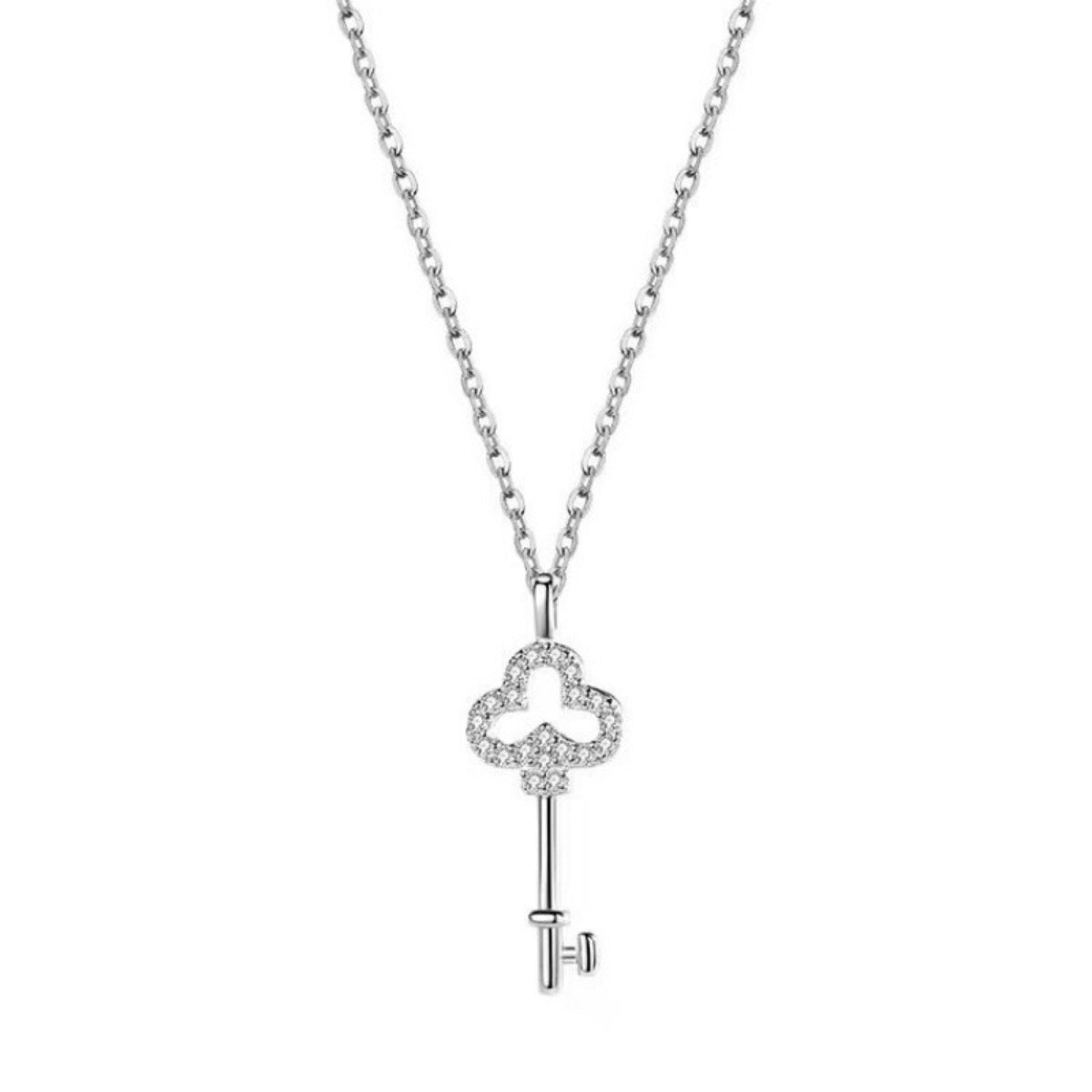 Silver key-shaped necklace pendant with clear stones shown on white