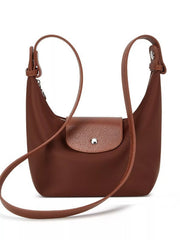 Front view of the brown shoulder bag with its long strap draped across the front.