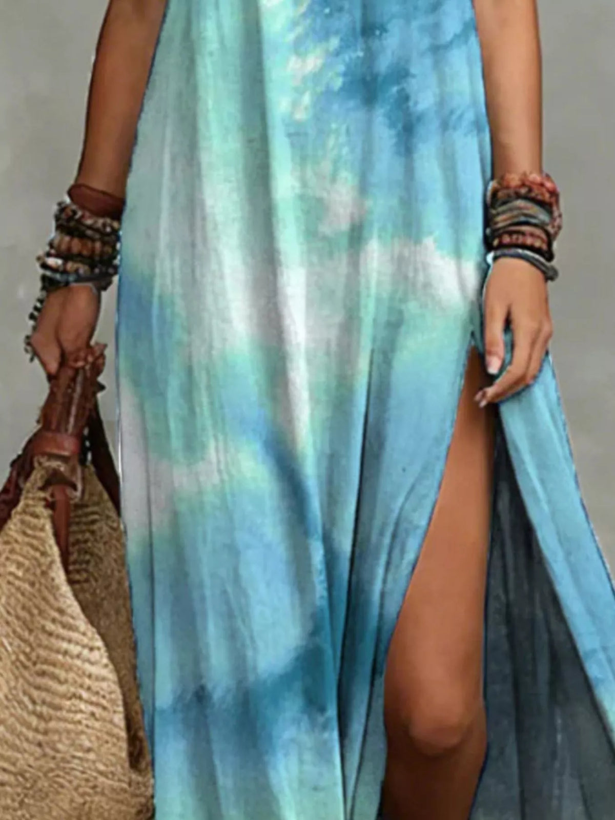 Close-up of the turquoise tie-dye fabric and side slit on the maxi dress.