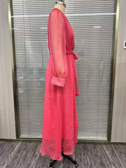 Side view of the pink wrap maxi dress on a dress form, showing the sleeve and layered skirt.
