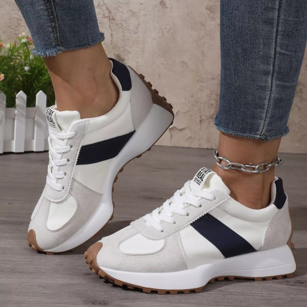 Pair of white sneakers with black panels viewed from above