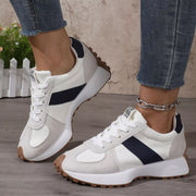 Pair of white sneakers with black panels viewed from above